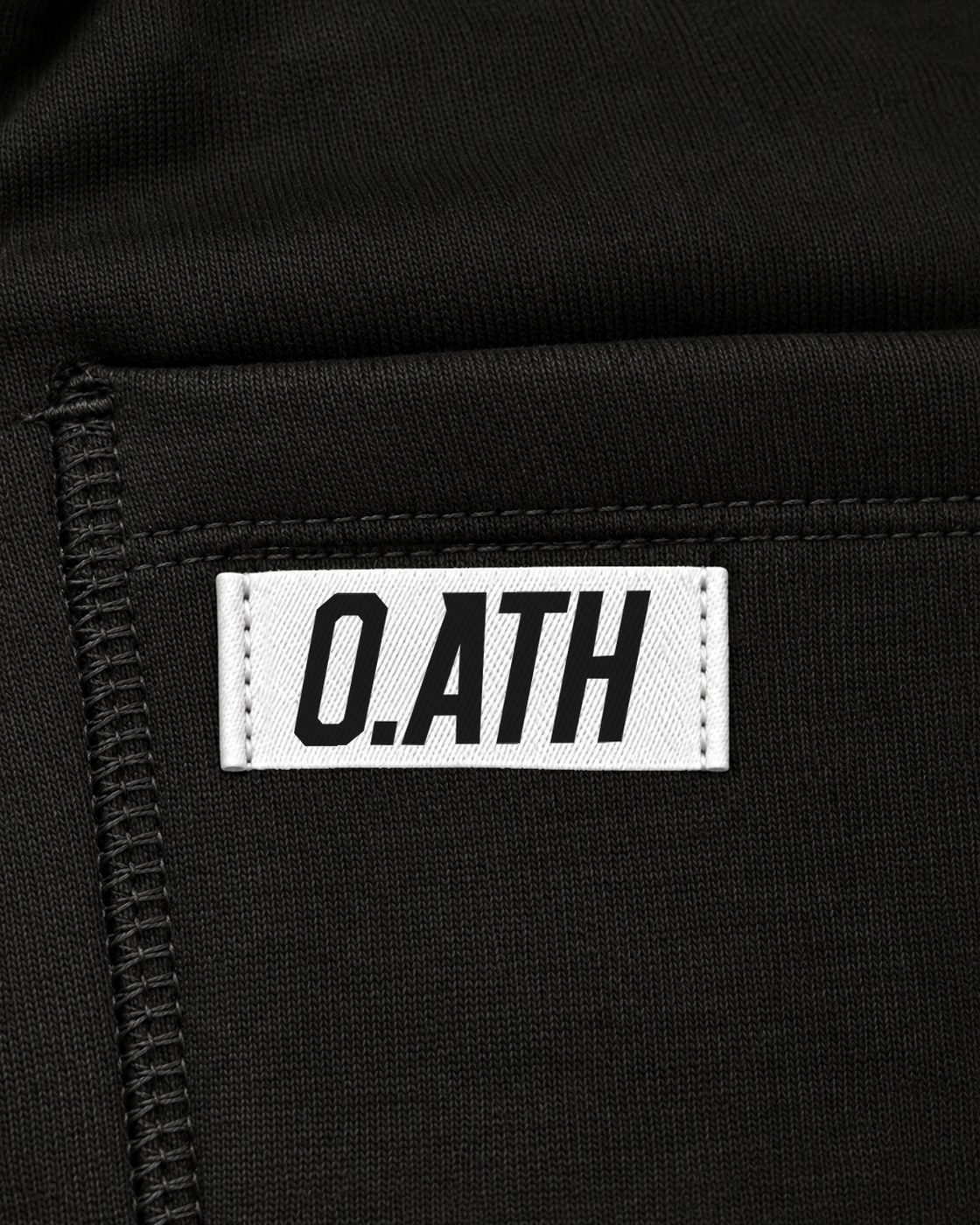 O.ATH Original Form joggers in Black — woven label and fabric detail