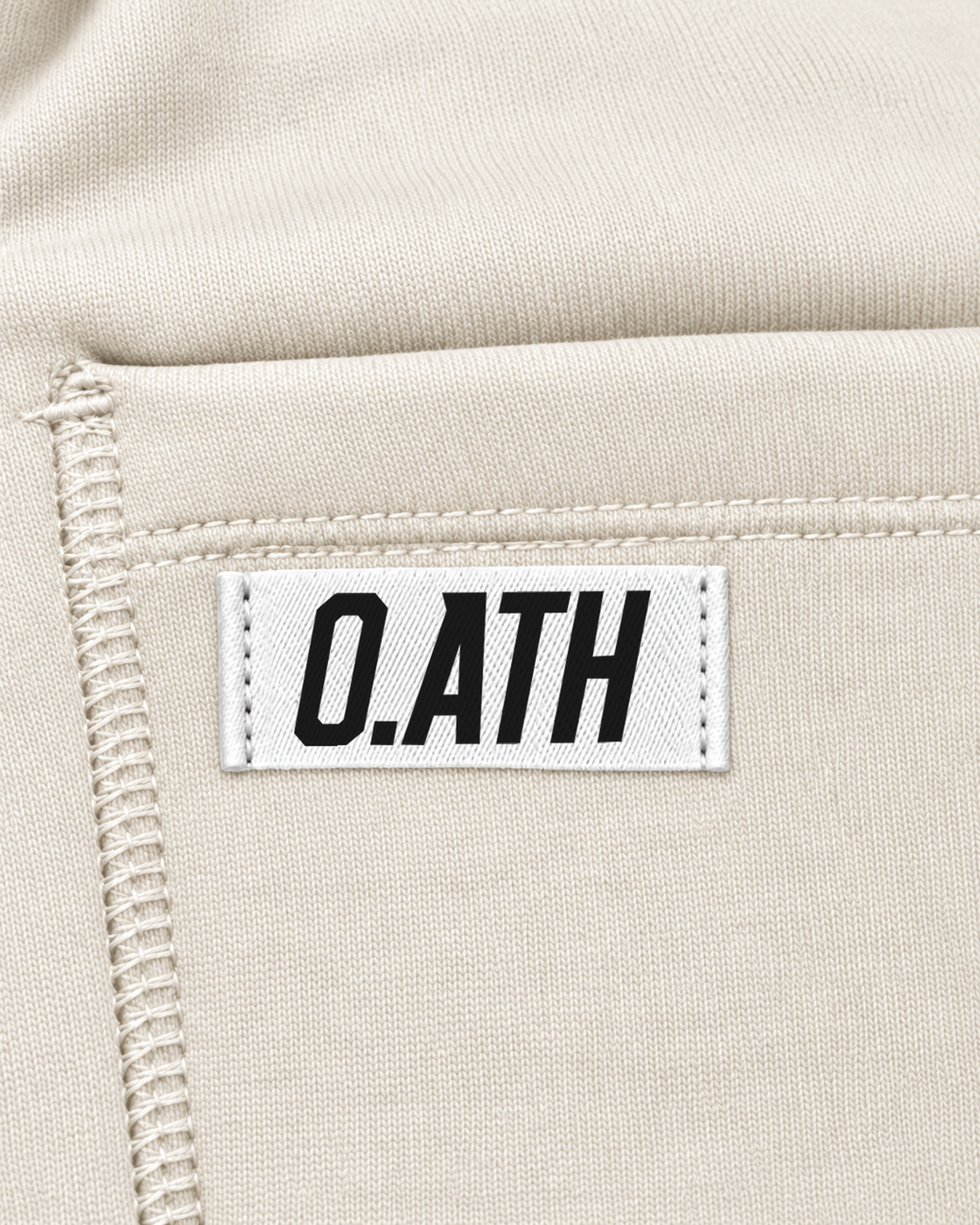 O.ATH Original Form joggers in Natural — woven label and fabric detail